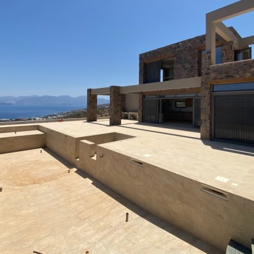 New built villa of 78 m² on two floors is available for sale in cosmopolitan Elounda, Crete.